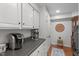 Well-organized kitchen featuring a modern coffee maker and stainless steel mixer on a solid countertop at 8504 Old Nc 86, Chapel Hill, NC 27516