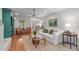 Comfortable living room featuring hardwood floors, a cozy sofa, and a view into the kitchen at 8504 Old Nc 86, Chapel Hill, NC 27516