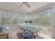 Bright sunroom with expansive windows, a wood dining table, and comfortable seating at 8504 Old Nc 86, Chapel Hill, NC 27516