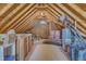 Large attic with wooden beams and carpet, offering great storage space at 8704 Paddle Wheel Dr, Raleigh, NC 27615