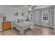 Cozy bedroom with natural light, hardwood floors, ceiling fan, and neutral paint at 8704 Paddle Wheel Dr, Raleigh, NC 27615