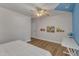 Spacious bedroom with ceiling fan, blue accent wall, white trim, and desk area at 8704 Paddle Wheel Dr, Raleigh, NC 27615