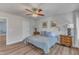 Bright bedroom with ceiling fan, hardwood floors, natural light, and neutral wall colors at 8704 Paddle Wheel Dr, Raleigh, NC 27615
