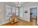 Sunlit breakfast nook with natural wood floors, stand alone island, and bright windows at 8704 Paddle Wheel Dr, Raleigh, NC 27615