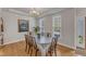 Elegant dining room with hardwood floors, chandelier, and a large window at 8704 Paddle Wheel Dr, Raleigh, NC 27615