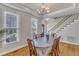 Elegant dining room with hardwood floors, chandelier, and staircase access at 8704 Paddle Wheel Dr, Raleigh, NC 27615