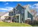 This home features a well maintained lawn, blue siding, and a screened in porch at 8704 Paddle Wheel Dr, Raleigh, NC 27615