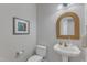 Stylish half bathroom with a pedestal sink, ornate mirror, and neutral wall color at 8704 Paddle Wheel Dr, Raleigh, NC 27615