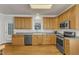 Well-lit kitchen with stainless steel appliances and light wood cabinetry at 8704 Paddle Wheel Dr, Raleigh, NC 27615