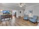 Spacious living room with hardwood floors, comfortable chairs, and kitchen access at 8704 Paddle Wheel Dr, Raleigh, NC 27615