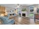 Cozy living room with a fireplace, built-in cabinets, hardwood floors, and ample natural light at 8704 Paddle Wheel Dr, Raleigh, NC 27615