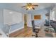 Bright home office featuring a whiteboard, ceiling fan and a wood desk at 8704 Paddle Wheel Dr, Raleigh, NC 27615
