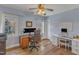 Light blue home office with hardwood floors, windows, desk, printer, and office chair at 8704 Paddle Wheel Dr, Raleigh, NC 27615