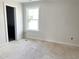 Bright room with a large window, fresh paint, and a neutral palette, ready for new flooring at 908 Colfax St, Durham, NC 27701