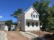 Exterior showing white siding, black roof, and concrete driveway at 908 Colfax St, Durham, NC 27701