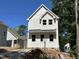 New exterior featuring board and batten siding and a dark metal roof in a new build neighborhood at 908 Colfax St, Durham, NC 27701
