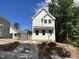 Exterior showing white siding, black roof, and concrete driveway at 908 Colfax St, Durham, NC 27701