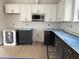 Modern kitchen with two-tone cabinets, stainless steel microwave, and a blank canvas for customization at 908 Colfax St, Durham, NC 27701