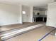 Open-concept room with new paint, leading into a modern kitchen, and ready for personalization at 908 Colfax St, Durham, NC 27701
