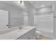 Bright bathroom with white countertops, vanity, white shower and tub, with a large mirror at 9152 Dupree Meadow Dr # 12, Angier, NC 27501