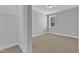 Bedroom with neutral carpet, light gray walls, closet and a view of the outside at 9152 Dupree Meadow Dr # 12, Angier, NC 27501