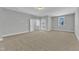 Large bedroom featuring neutral carpet, light gray walls, windows and doors at 9152 Dupree Meadow Dr # 12, Angier, NC 27501