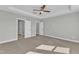 Large bedroom with carpet, ceiling fan, and multiple doors at 9152 Dupree Meadow Dr # 12, Angier, NC 27501