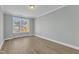 Inviting bedroom featuring neutral paint, a window with natural light, and wood-look flooring at 9152 Dupree Meadow Dr # 12, Angier, NC 27501