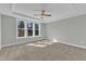 Bright bedroom features a ceiling fan, carpet, and large windows at 9152 Dupree Meadow Dr # 12, Angier, NC 27501