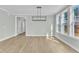 Bright dining area with luxury vinyl floors and modern light fixture at 9152 Dupree Meadow Dr # 12, Angier, NC 27501