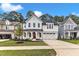 Inviting new construction two-story home with a red door, manicured lawn, and attached two car garage at 9152 Dupree Meadow Dr # 12, Angier, NC 27501