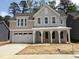 Charming two-story home featuring a two-car garage, covered porch, and light gray siding at 9152 Dupree Meadow Dr # 12, Angier, NC 27501
