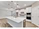 Modern kitchen with white cabinets, stainless steel appliances, and a large island with pendant lighting at 9152 Dupree Meadow Dr # 12, Angier, NC 27501