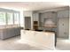 Unfinished kitchen featuring gray cabinets, a white island, and large windows allowing natural light at 9152 Dupree Meadow Dr # 12, Angier, NC 27501