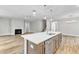 Open kitchen featuring a large island with seating, stainless steel appliances, and views to the fireplace at 9152 Dupree Meadow Dr # 12, Angier, NC 27501