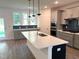 Bright kitchen boasts a large island, stainless appliances, and oversized windows providing ample natural light at 9152 Dupree Meadow Dr # 12, Angier, NC 27501
