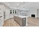 Open kitchen featuring a large island with seating, stainless steel appliances, and an adjacent living space at 9152 Dupree Meadow Dr # 12, Angier, NC 27501