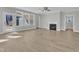 Bright living room with hardwood floors, fireplace, ceiling fan, and large windows at 9152 Dupree Meadow Dr # 12, Angier, NC 27501
