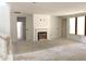 Unfinished living room with fireplace, doorframes, and large window with view outside at 9152 Dupree Meadow Dr # 12, Angier, NC 27501