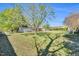 Expansive backyard featuring lush lawn, mature trees, and covered porch at 99 Stoney Hill Ln, Sanford, NC 27332