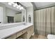 Well-maintained bathroom features a vanity, large mirror, and shower with curtain at 99 Stoney Hill Ln, Sanford, NC 27332