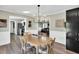 Open-concept dining room with stylish chandelier and seamless connection to the kitchen and living room areas at 99 Stoney Hill Ln, Sanford, NC 27332