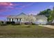 Charming ranch-style home with a well-maintained front yard, inviting porch, and attached two-car garage at 99 Stoney Hill Ln, Sanford, NC 27332