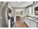 Open kitchen view showcases white cabinets, granite counters, and stainless steel appliances at 99 Stoney Hill Ln, Sanford, NC 27332