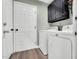 Convenient laundry room equipped with a washer, dryer, and overhead storage cabinets at 99 Stoney Hill Ln, Sanford, NC 27332