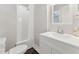 All-white bathroom featuring a walk-in shower and a new vanity at 1001 Helms Pl, Raleigh, NC 27610