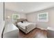 Bright bedroom featuring hardwood floors, neutral walls, and a tufted headboard at 1001 Helms Pl, Raleigh, NC 27610