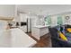 Bright kitchen featuring an island with a sink and stainless steel appliances, and hardwood floors at 1001 Helms Pl, Raleigh, NC 27610