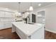 Bright kitchen with a large white island, stainless steel appliances, and pendant lighting at 1001 Helms Pl, Raleigh, NC 27610