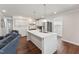 Bright kitchen with a large white island, stainless steel appliances, and pendant lighting at 1001 Helms Pl, Raleigh, NC 27610